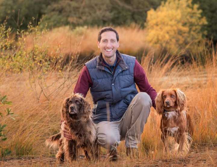 Kevin with his two spaniel type dogs